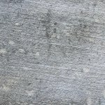 Close up of a yellowish grey building stone with laminations